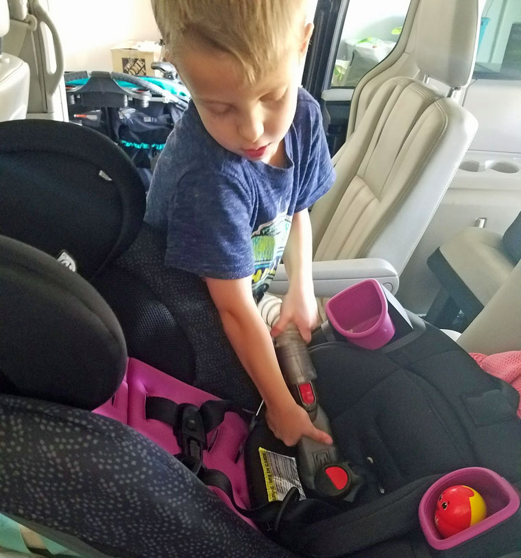 Boy vacuuming the car