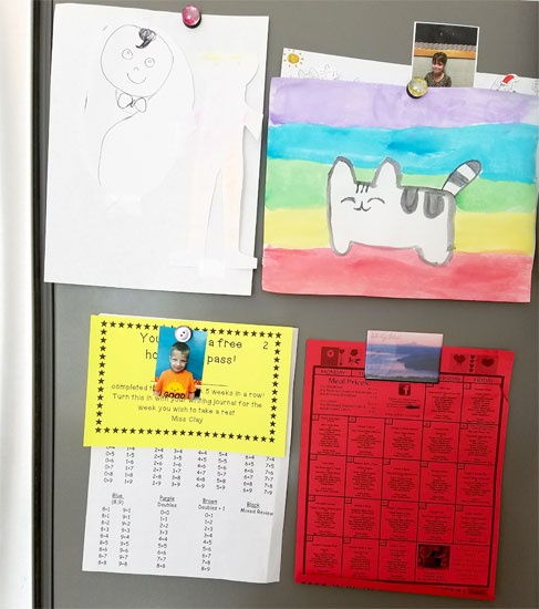 Children's artwork on a fridge.