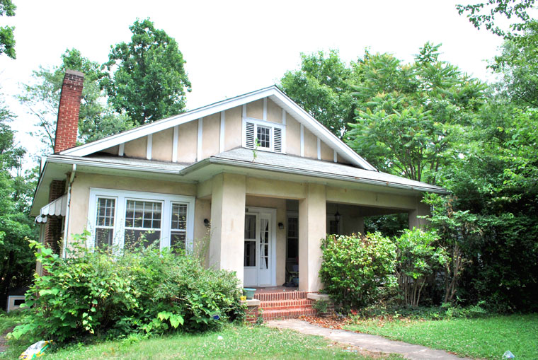 Pale peach 1920's home surrounded by trees - Hope for a Messy House