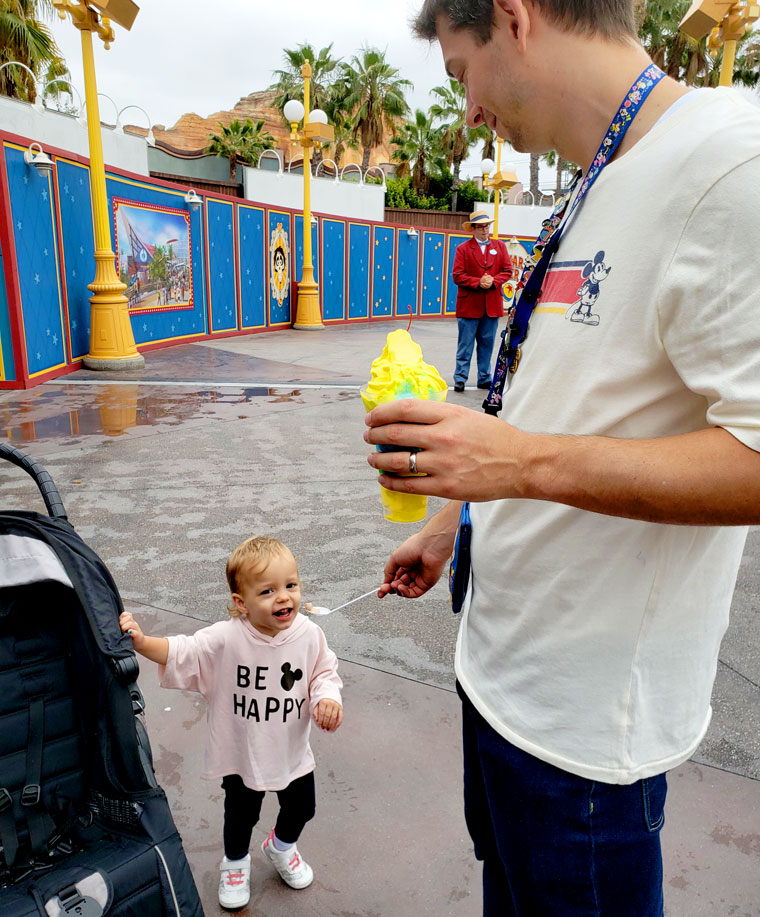 Baby snacking on ice cream at Disneyland's DCA park.