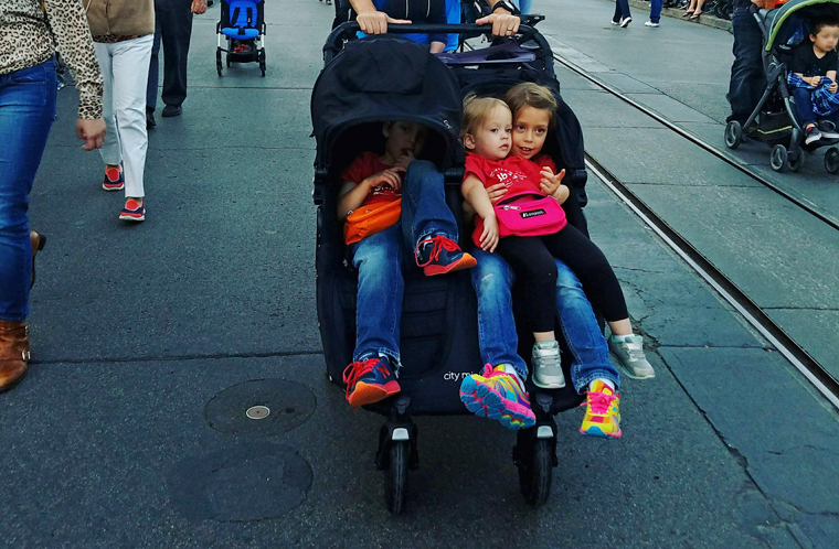 Tired kids in a Traveling Baby Company double stroller at Disneyland in Anaheim, CA.