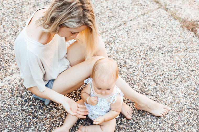 Lonely mom sitting with her baby daughter.