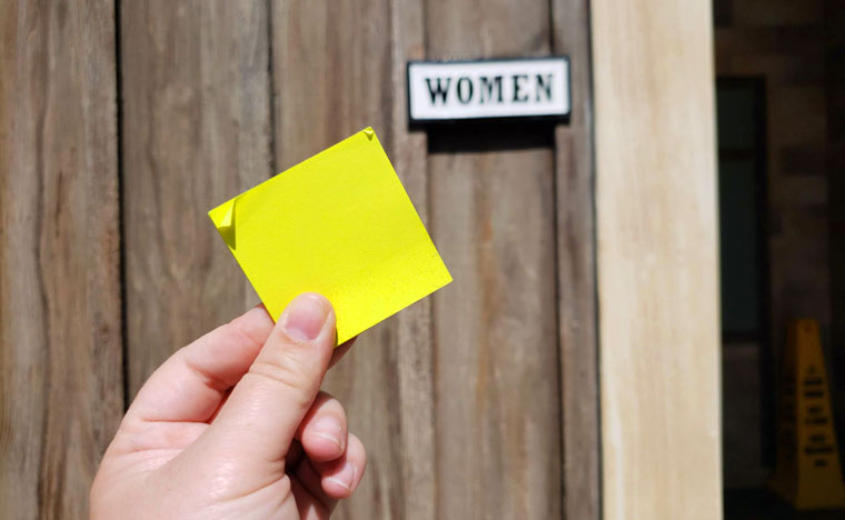 Hand holding yellow sticky notes