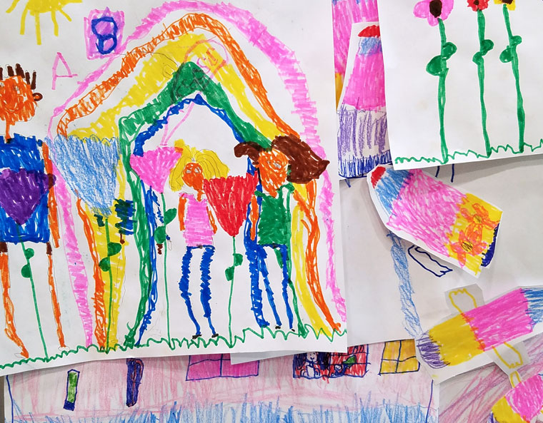Stack of colorful pictures drawn by a young child.