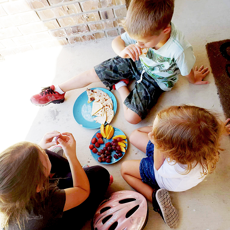 Kids eating a snack on the porch after school