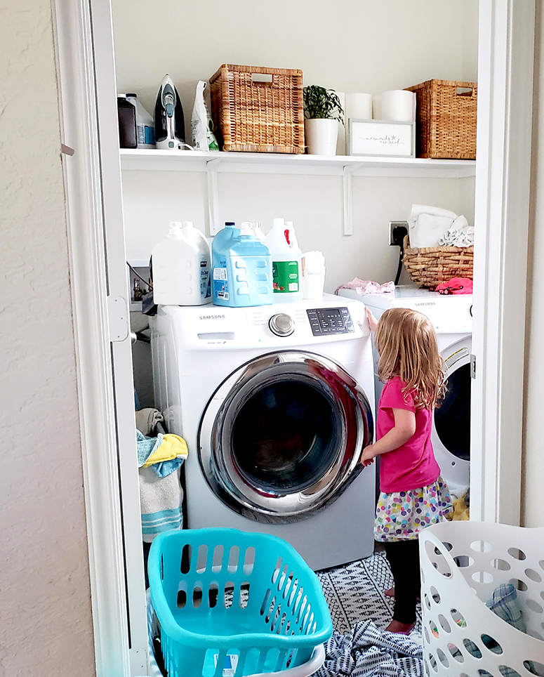 Kindergartener doing laundry.