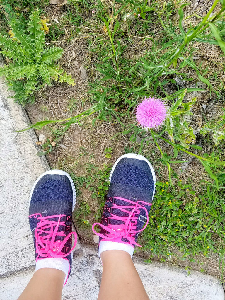 Feet in running shoes with flower