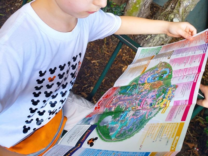 Boy reading Disneyland map.