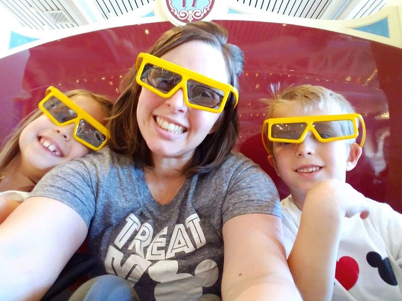 Mom riding Toy Story Midway Mania with her kids at Disney California Adventure.