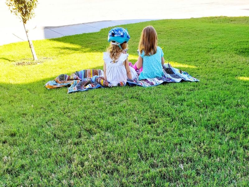 Sisters sitting on a blanket