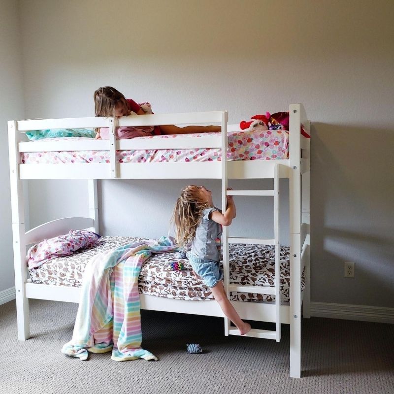 Girls climbing on bunk bed