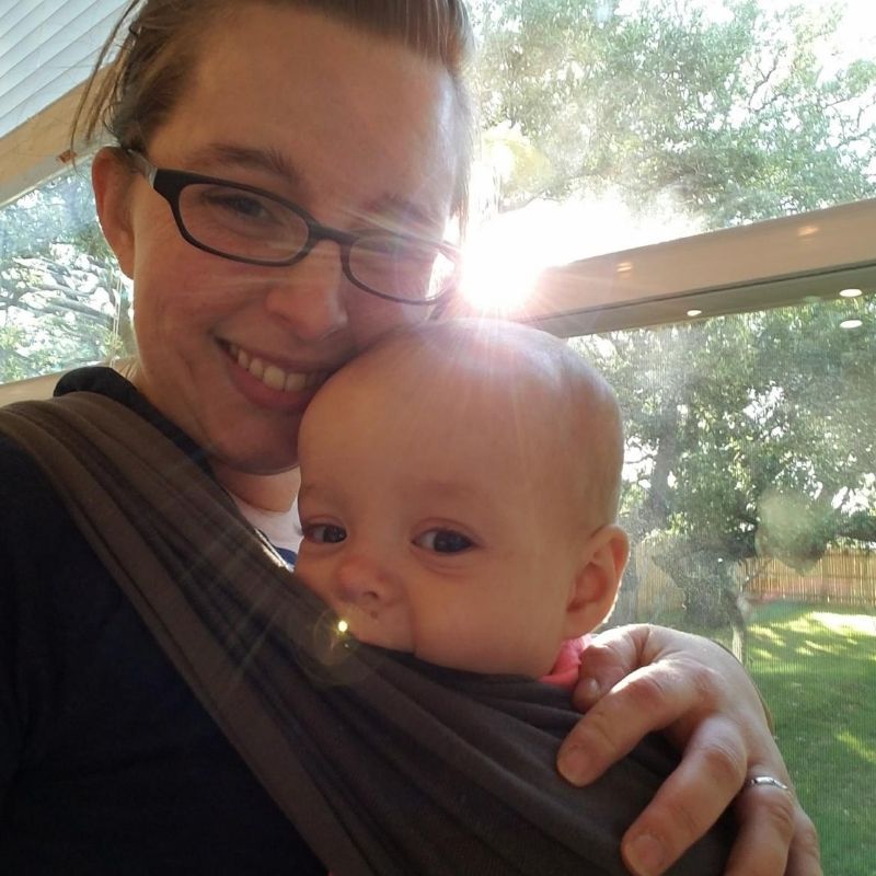 Mom holding baby in a sling