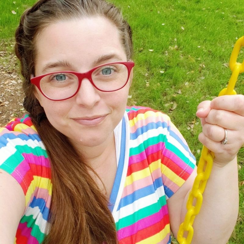 Mom taking a break from kids on her backyard swing.