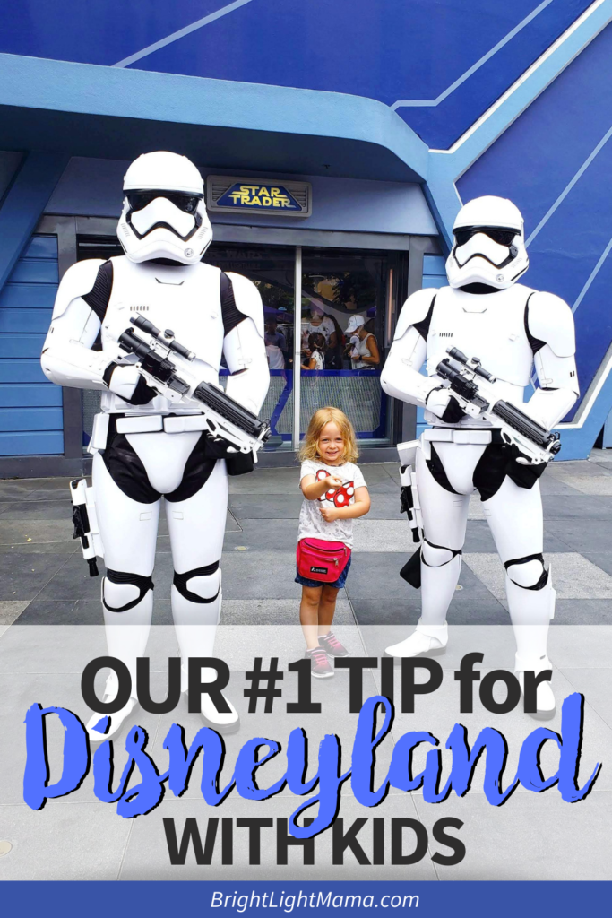 Pin image for Disneyland tips with kids post with a little girl posing with storm troopers